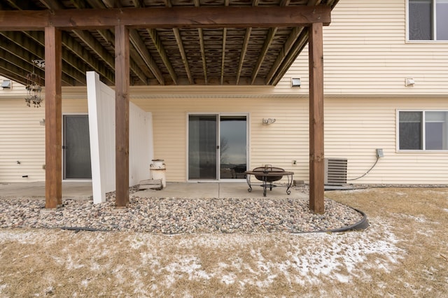 exterior space featuring an outdoor fire pit, central AC unit, and a patio area