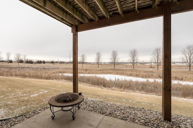 view of patio featuring a rural view and a fire pit