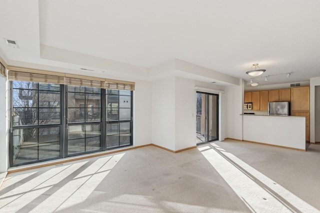 unfurnished living room featuring light carpet