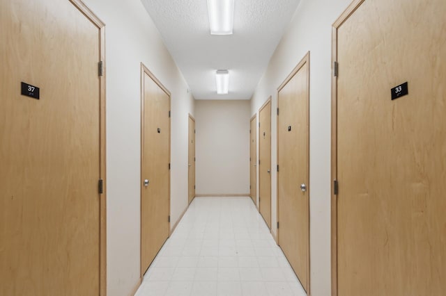 hallway with a textured ceiling