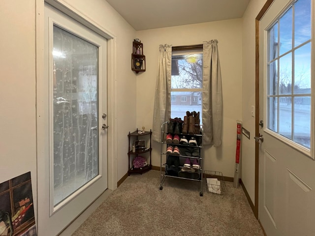 doorway to outside with carpet floors