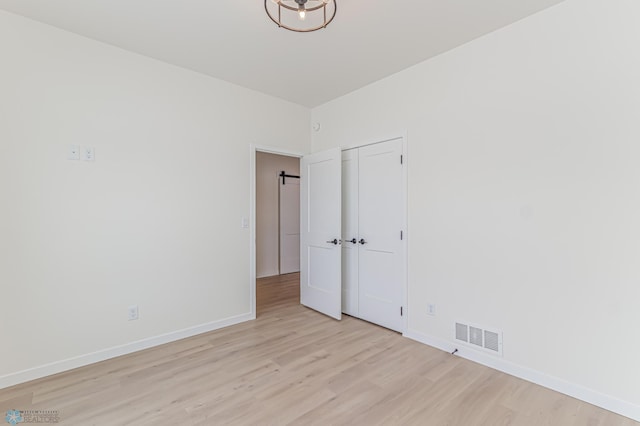 empty room with light hardwood / wood-style flooring