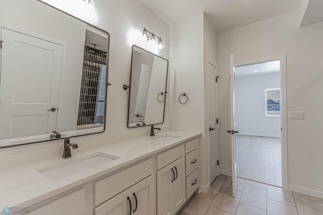 bathroom featuring tile patterned flooring and vanity