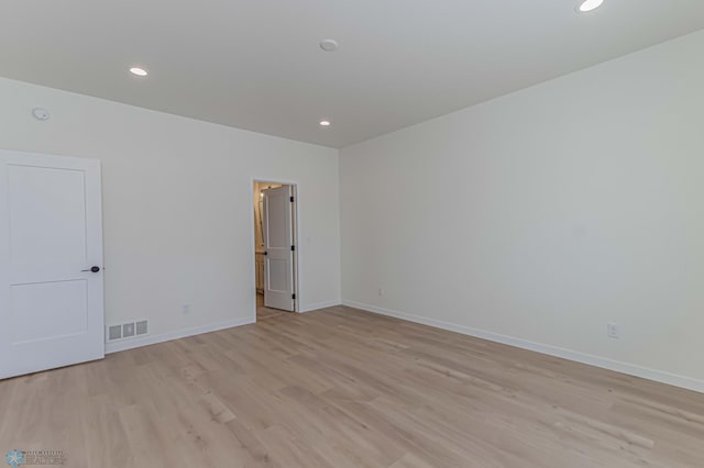 spare room with light hardwood / wood-style flooring