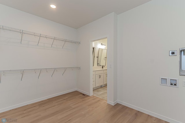 spacious closet featuring light wood-type flooring