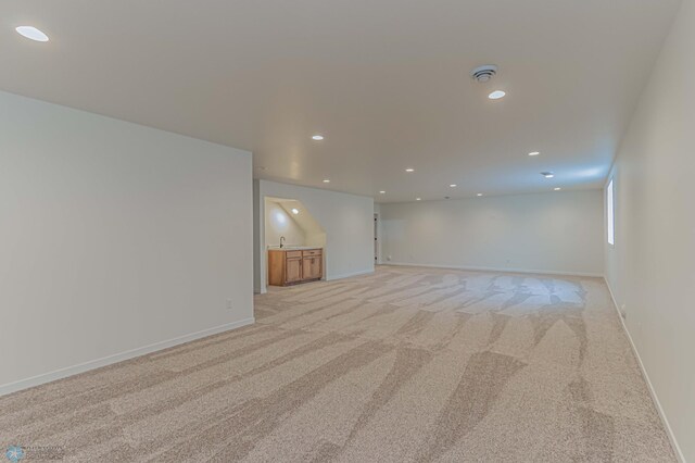 carpeted spare room with sink