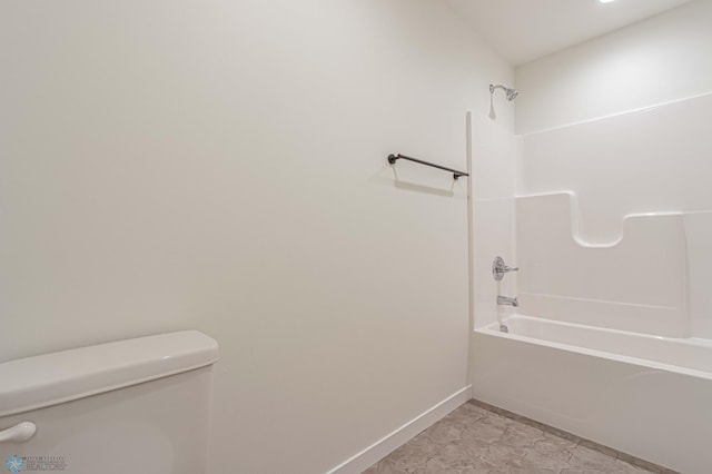 bathroom with shower / bathtub combination and toilet