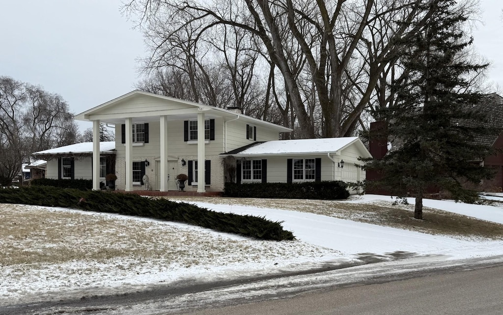 greek revival house featuring a garage