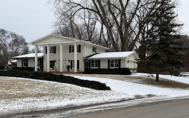 greek revival house featuring a garage