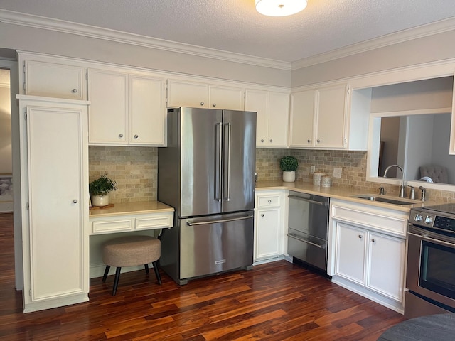 kitchen with sink, appliances with stainless steel finishes, white cabinetry, dark hardwood / wood-style floors, and tasteful backsplash