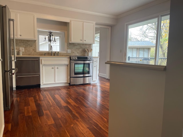 kitchen featuring backsplash, ornamental molding, stainless steel appliances, and white cabinets