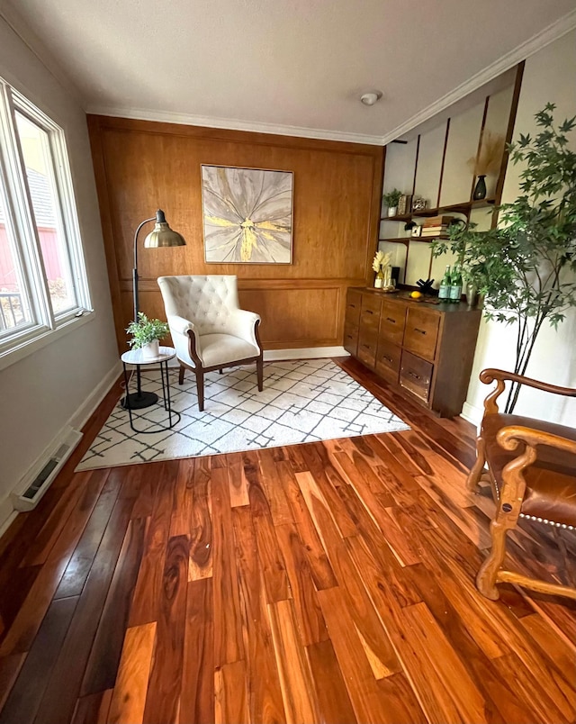 living area featuring ornamental molding and light wood-type flooring