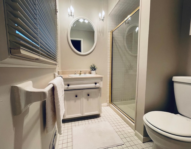 bathroom with toilet, vanity, tile patterned floors, and a shower with shower door