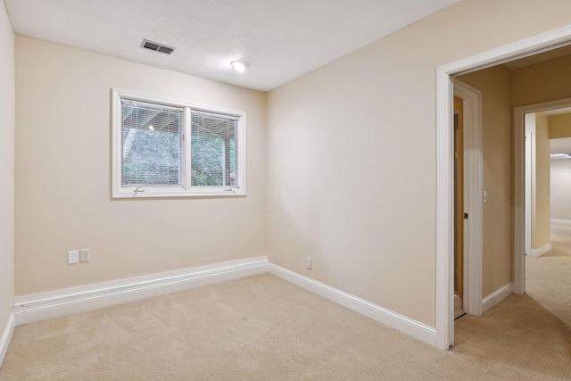 spare room with light colored carpet