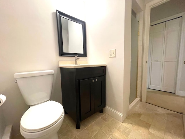 bathroom featuring vanity, toilet, and a shower