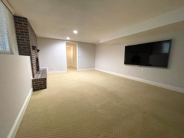 unfurnished living room featuring carpet and a brick fireplace