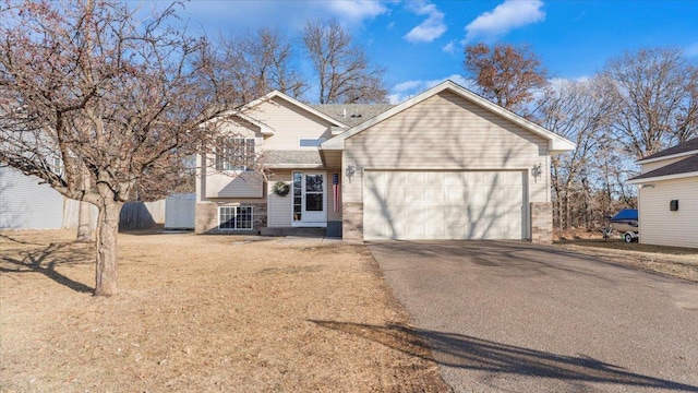 view of front of home with aphalt driveway and an attached garage