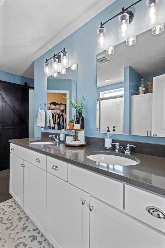 bathroom with vanity and a textured ceiling