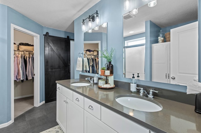 bathroom with vanity and a textured ceiling