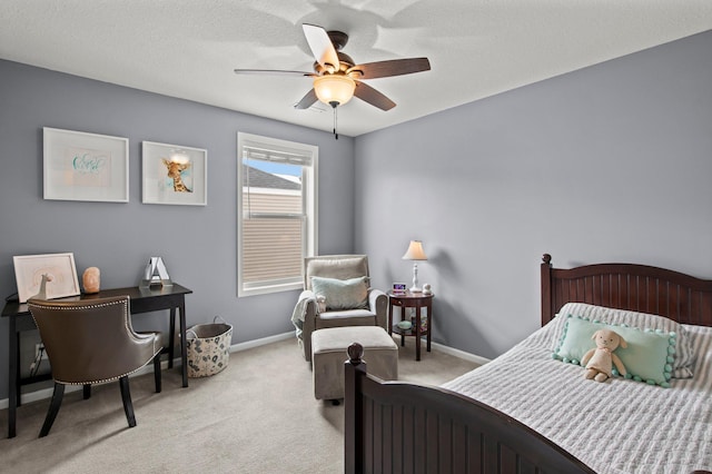 carpeted bedroom featuring ceiling fan and a textured ceiling