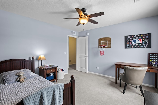 carpeted bedroom featuring ceiling fan and a textured ceiling