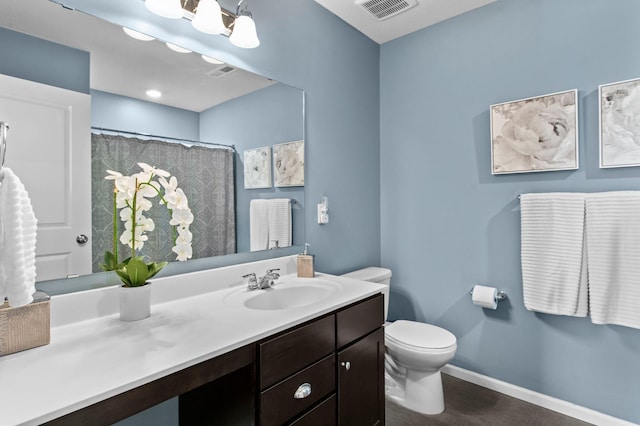 bathroom with vanity, a shower with shower curtain, and toilet