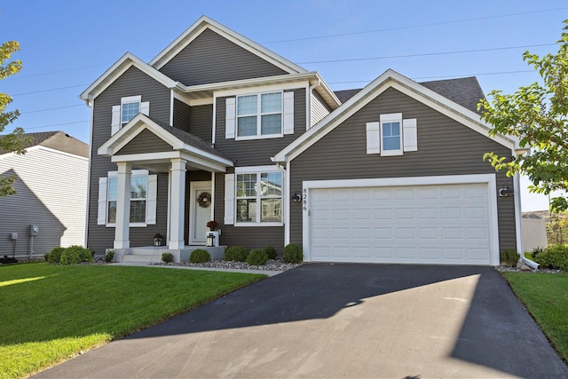 view of front of home with a garage and a front lawn