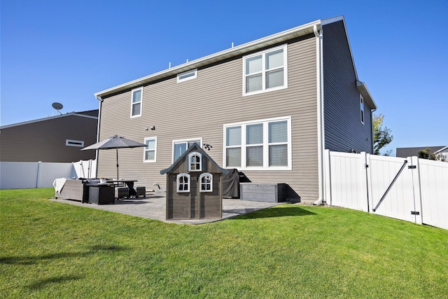 back of house featuring a yard and a patio