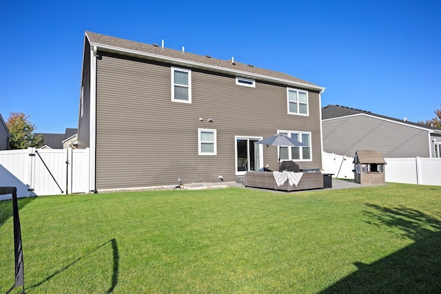 back of house featuring an outdoor living space, a patio area, and a lawn