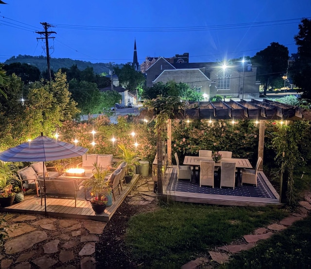 706 4th St, Red Wing, MN 55066 - yard at twilight featuring a deck, a fire pit, and outdoor dining space