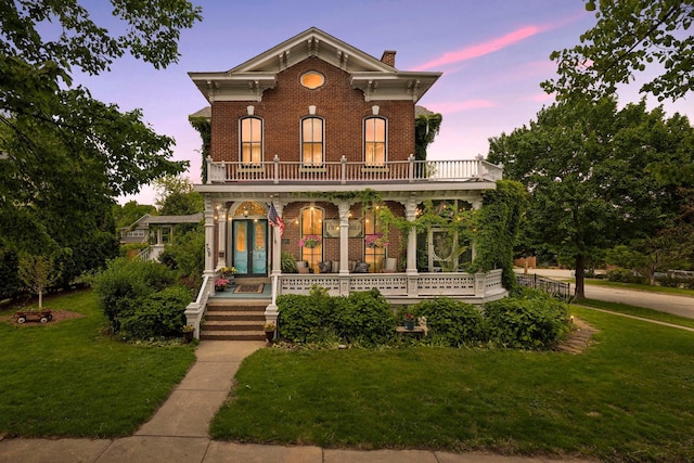 706 4th St, Red Wing, MN 55066 - italianate-style house with a porch, brick siding, a balcony, a chimney, and a yard