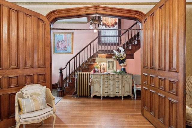 706 4th St, Red Wing, MN 55066 - entrance foyer with light wood-style floors, stairway, radiator, and a chandelier