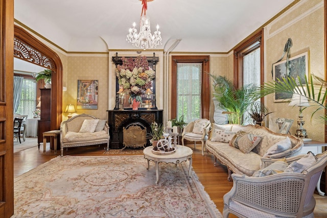706 4th St, Red Wing, MN 55066 - living room with a chandelier, wood finished floors, and wallpapered walls