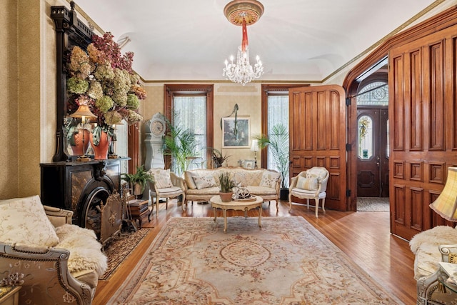 706 4th St, Red Wing, MN 55066 - living room featuring a chandelier, wood finished floors, healthy amount of natural light, and arched walkways
