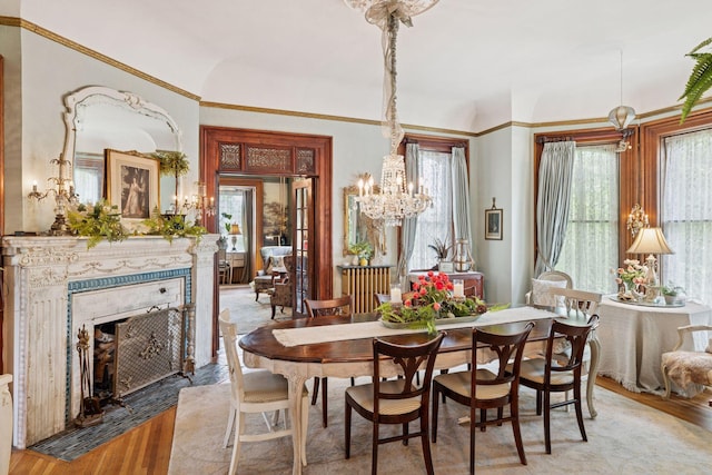 706 4th St, Red Wing, MN 55066 - dining space with light wood-style floors, a chandelier, and a fireplace