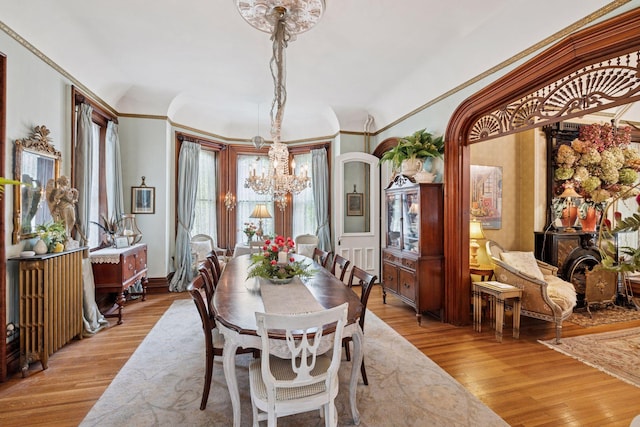 706 4th St, Red Wing, MN 55066 - dining area with a chandelier, light wood-style floors, ornamental molding, and arched walkways