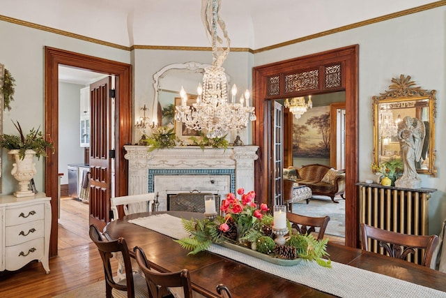 706 4th St, Red Wing, MN 55066 - dining space featuring a chandelier, hardwood / wood-style floors, and a fireplace