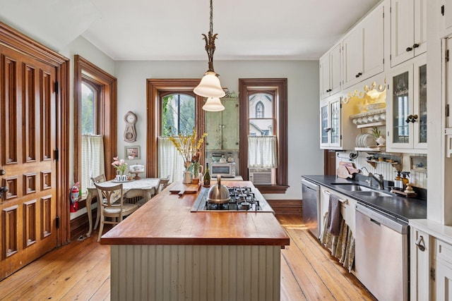 706 4th St, Red Wing, MN 55066 - kitchen with stainless steel appliances, butcher block countertops, a sink, light wood-type flooring, and white cabinets