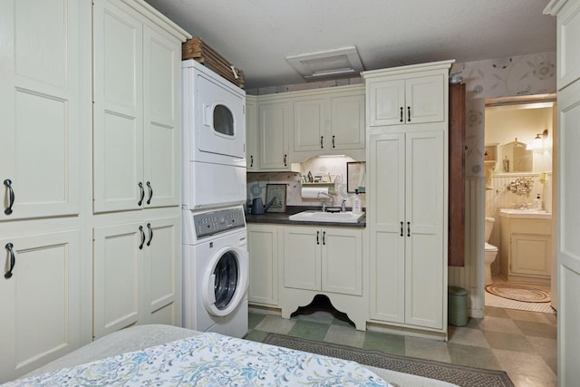 706 4th St, Red Wing, MN 55066 - bedroom featuring stacked washer / drying machine, a sink, attic access, tile patterned floors, and connected bathroom