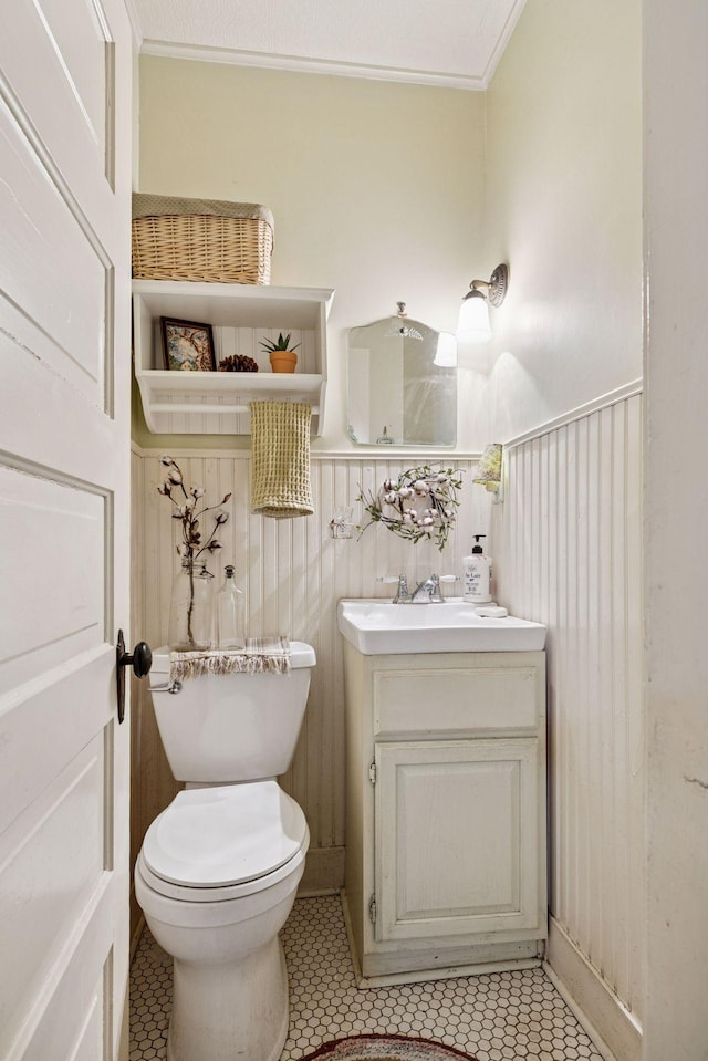 706 4th St, Red Wing, MN 55066 - bathroom with vanity, wainscoting, tile patterned flooring, ornamental molding, and toilet