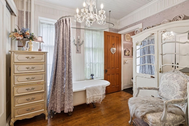 706 4th St, Red Wing, MN 55066 - bathroom featuring a freestanding bath, a chandelier, crown molding, wood finished floors, and toilet