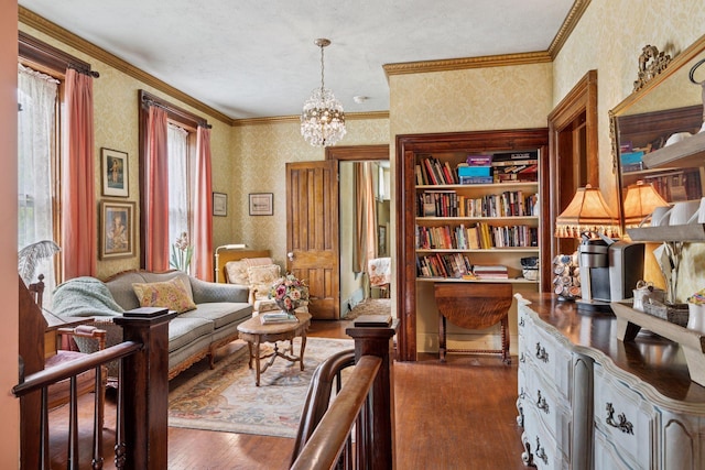 706 4th St, Red Wing, MN 55066 - living area with wallpapered walls, hardwood / wood-style flooring, a chandelier, and ornamental molding