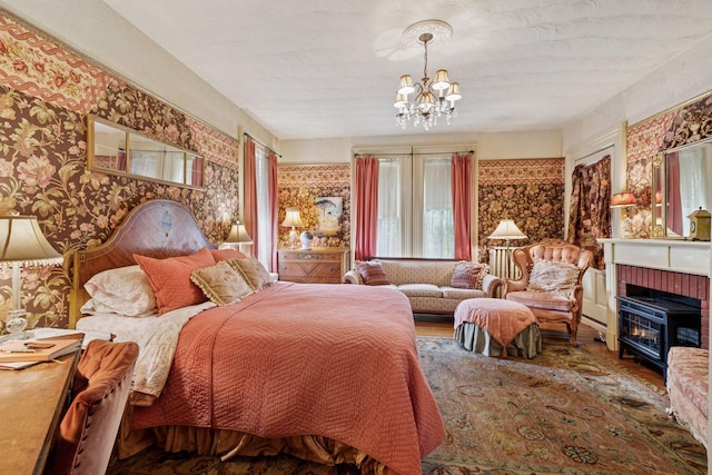 706 4th St, Red Wing, MN 55066 - bedroom with wallpapered walls, a chandelier, and wood finished floors