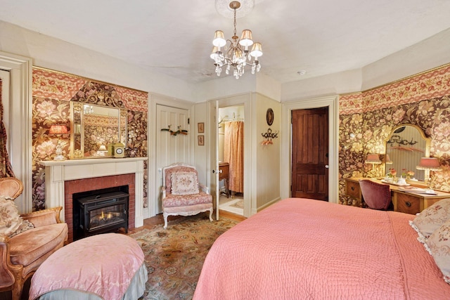 706 4th St, Red Wing, MN 55066 - bedroom featuring a chandelier, wood finished floors, and a tile fireplace