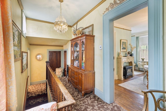 706 4th St, Red Wing, MN 55066 - hallway with a chandelier, baseboards, ornamental molding, wood finished floors, and an upstairs landing