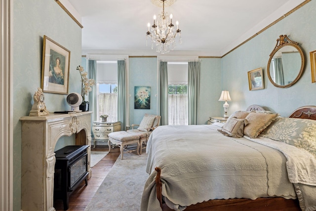 706 4th St, Red Wing, MN 55066 - bedroom with dark wood-style floors, a chandelier, and crown molding