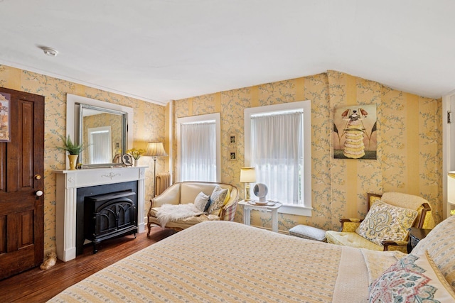 706 4th St, Red Wing, MN 55066 - bedroom featuring wood finished floors, wallpapered walls, and a fireplace