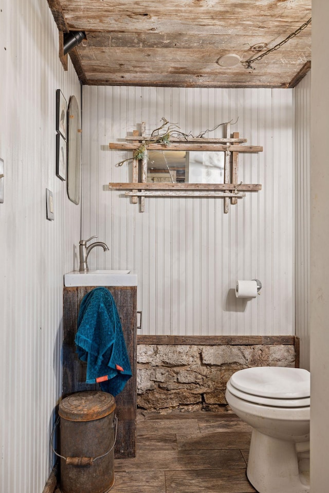 706 4th St, Red Wing, MN 55066 - half bath featuring toilet, wood-type flooring, wooden ceiling, and wood walls