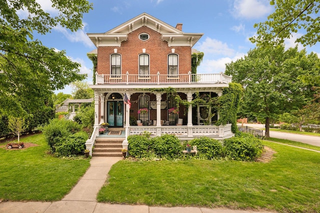 706 4th St, Red Wing, MN 55066 - italianate-style house featuring a porch, a chimney, a front yard, brick siding, and a balcony