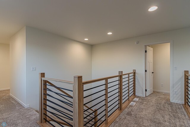 hallway featuring light carpet